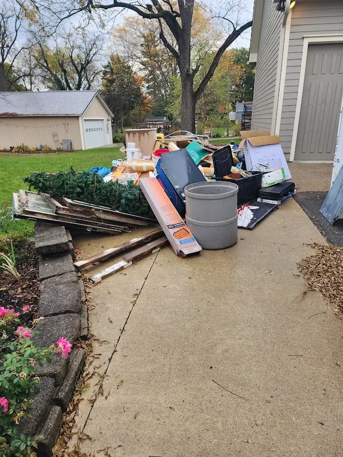 Dumpster being loaded with debris for Estate Cleanout Dumpster Rental in Randolph